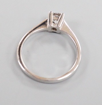A modern 750 white metal and solitaire princes cut diamond set ring, size L/M, gross weight 2.6 grams